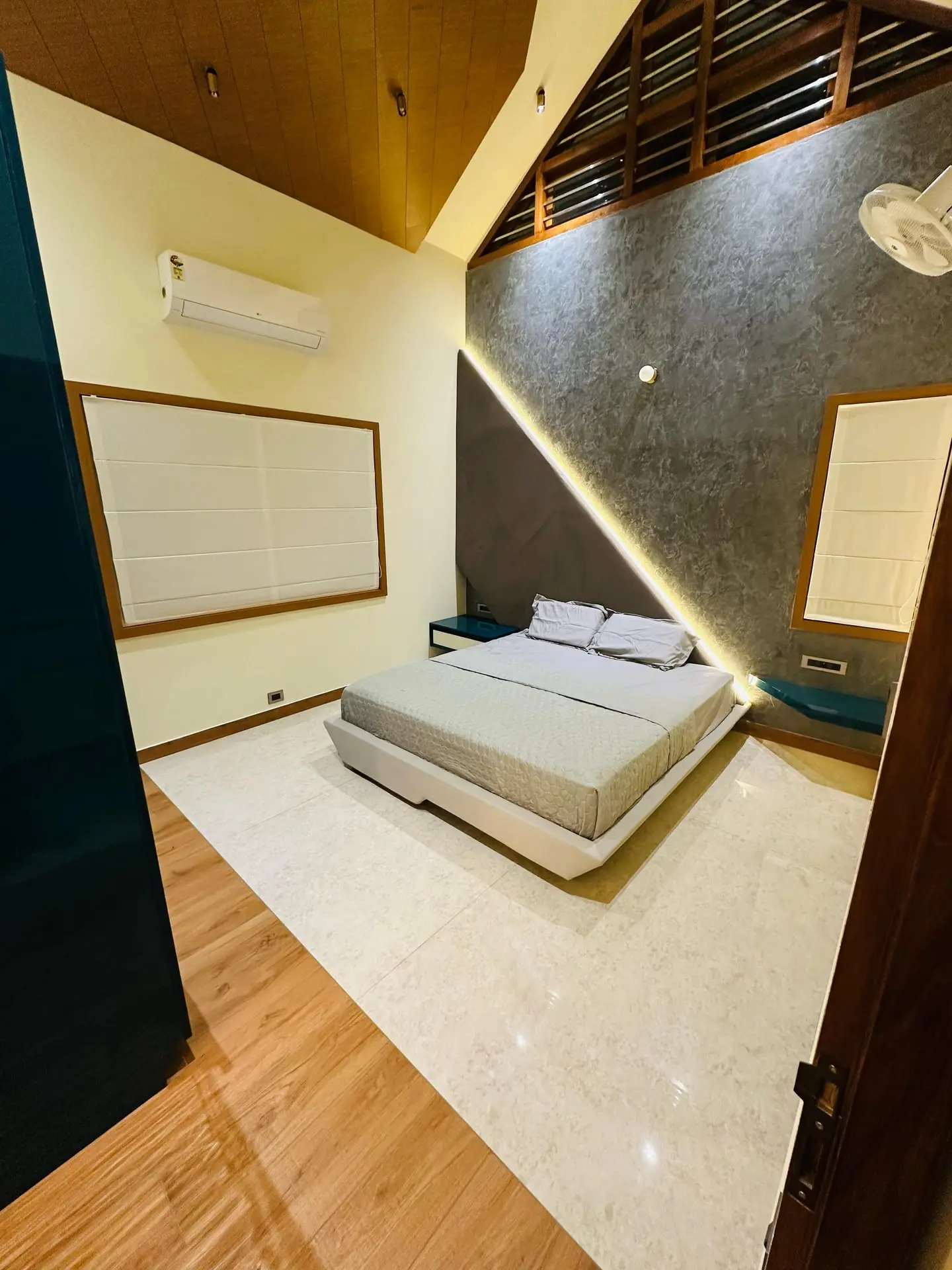 Billion Dreams interior — bedroom with stone accent wall and vaulted timber ceiling